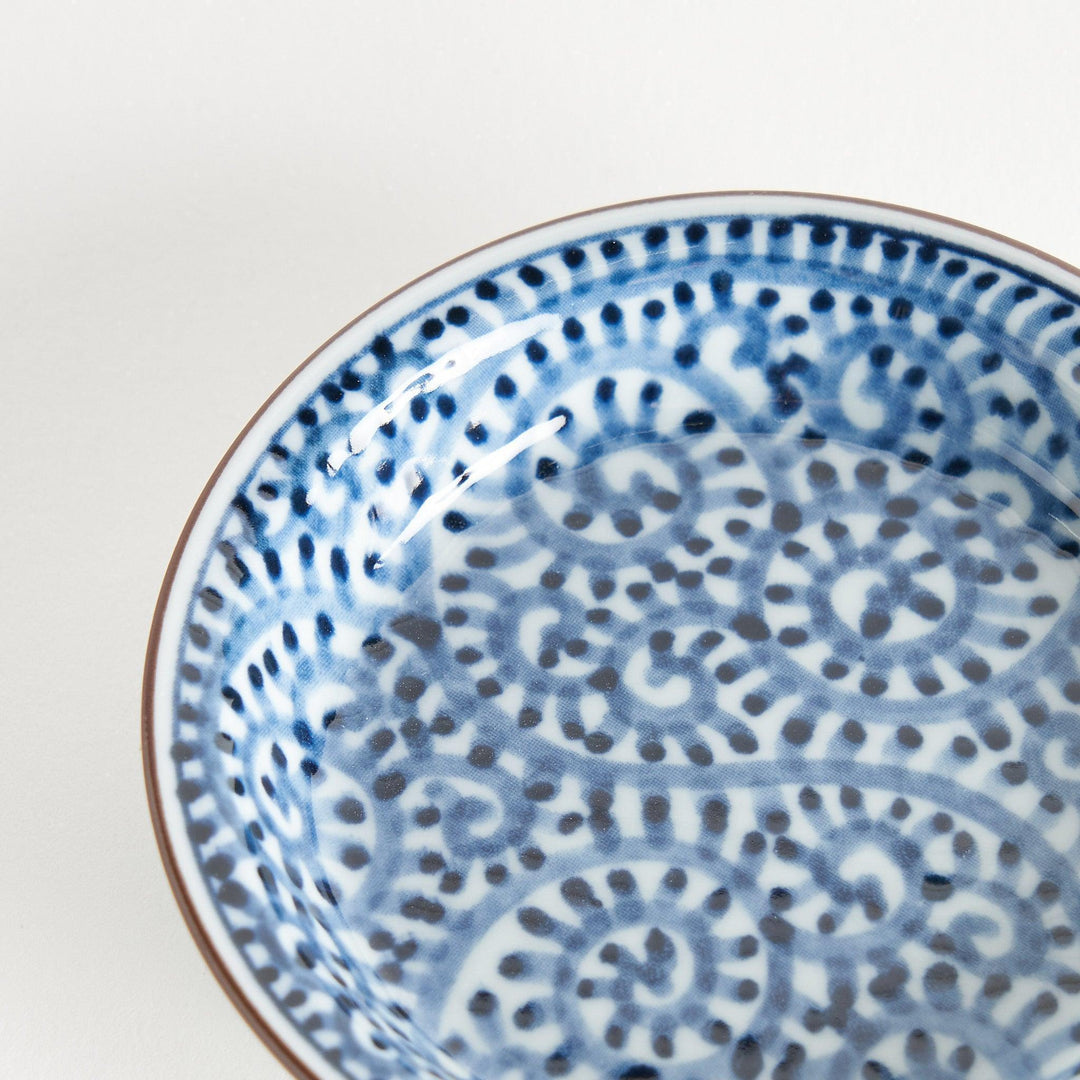 A round saucer with traditional blue floral patterns.