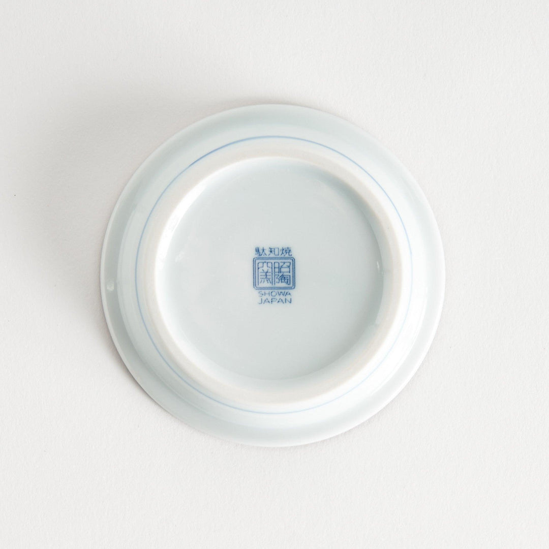 A round saucer with traditional blue floral patterns.