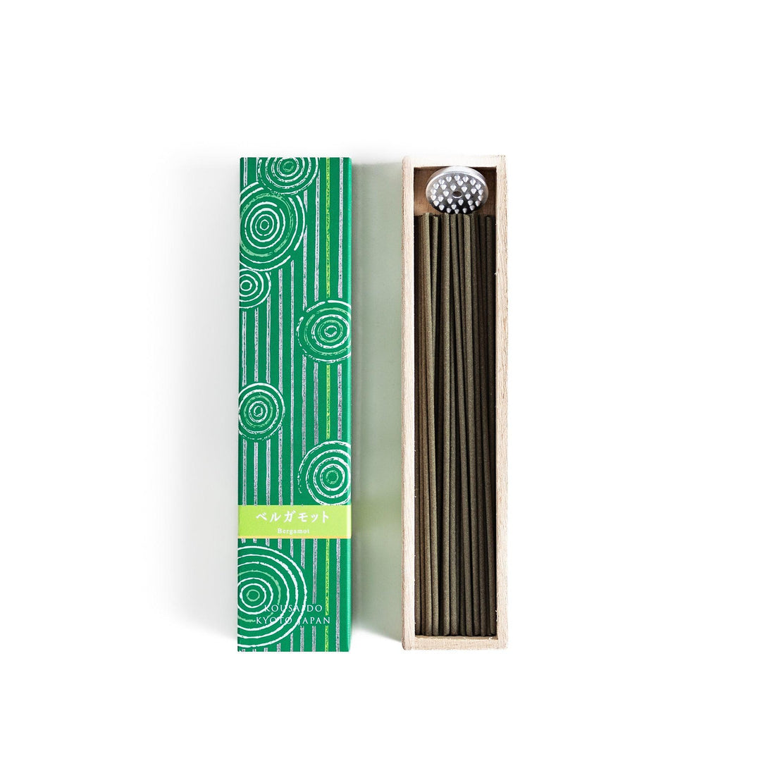 Japanese bergamot incense sticks in a wooden box with a bright green patterned sleeve from Kyoto’s Kousaido