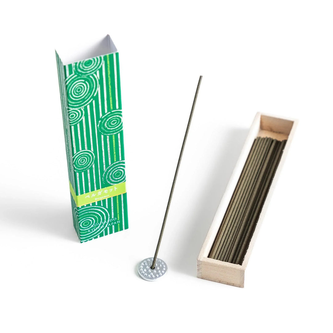 Japanese bergamot incense sticks in a wooden box with a bright green patterned sleeve from Kyoto’s Kousaido