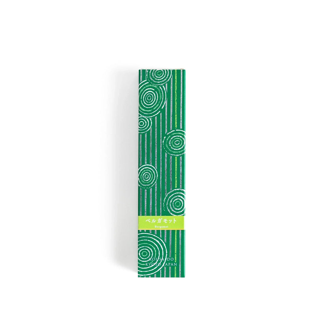 Japanese bergamot incense sticks in a wooden box with a bright green patterned sleeve from Kyoto’s Kousaido
