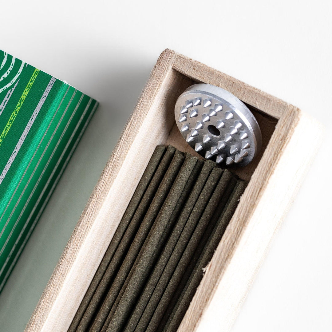 Japanese bergamot incense sticks in a wooden box with a bright green patterned sleeve from Kyoto’s Kousaido