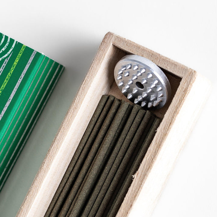 Japanese bergamot incense sticks in a wooden box with a bright green patterned sleeve from Kyoto’s Kousaido