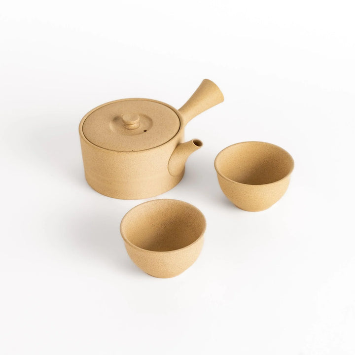 Elegant beige tea set featuring a round teapot with spout and matching bowls, perfect for enjoying your favorite tea.