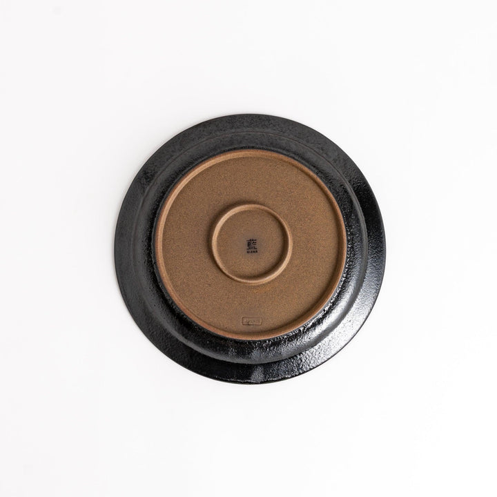 Black ceramic dinner plate with glossy finish and smooth texture offering minimalist elegance to any dining table.