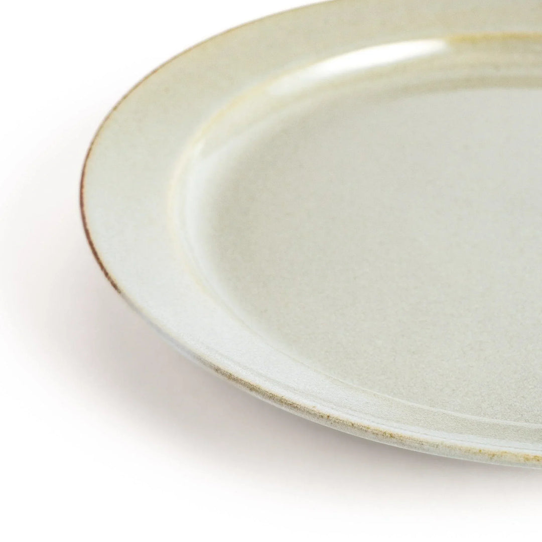 White ceramic dinner plate with a glossy finish, offering a clean and timeless design perfect for various table settings.