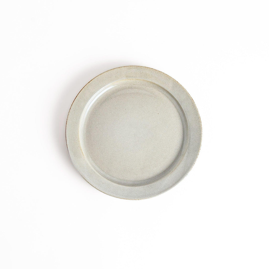 White ceramic dinner plate with a glossy finish, offering a clean and timeless design perfect for various table settings.