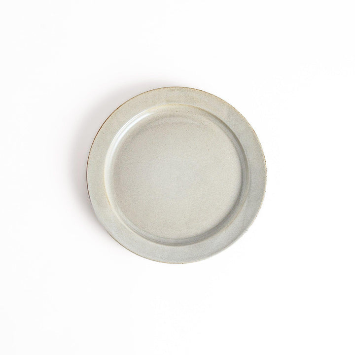 White ceramic dinner plate with a glossy finish, offering a clean and timeless design perfect for various table settings.