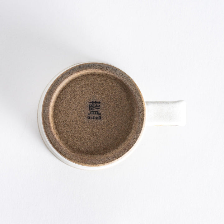 Bottom view of the white ceramic mug, showing its clean design with a neutral-toned base.