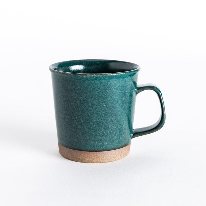 Front view of a green ceramic mug with a glossy finish and neutral-toned base, creating a simple yet modern look.