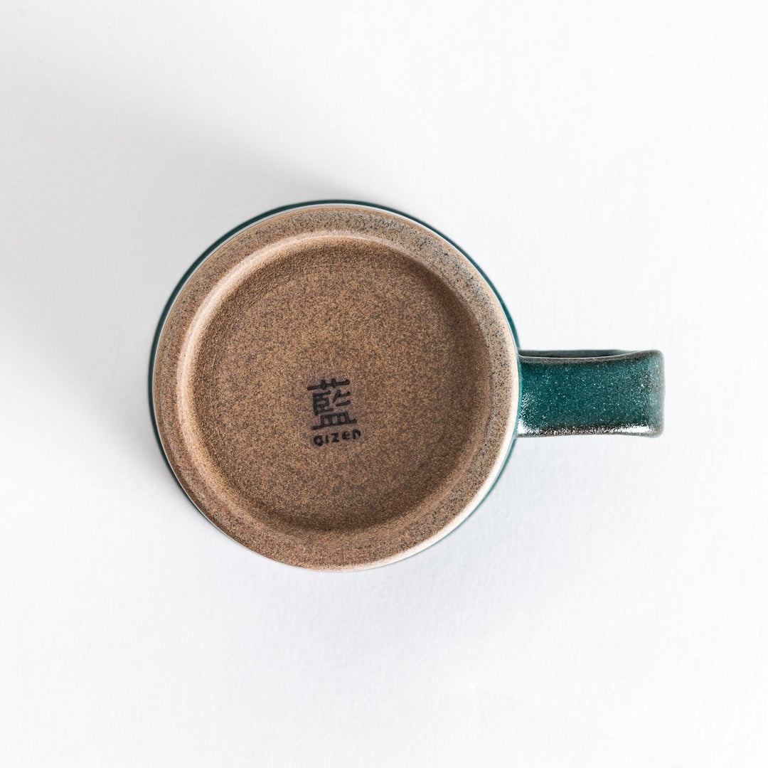 Colorful mug in blue red green yellow white or black with glossy finish and natural clay base on wooden block.