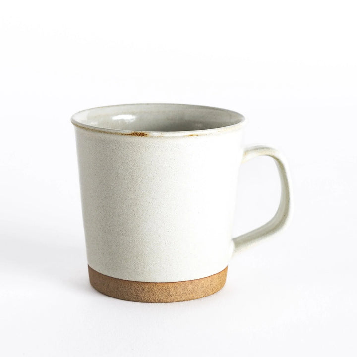 Front view of a white ceramic mug with a neutral-toned base, perfect for cozy beverages.