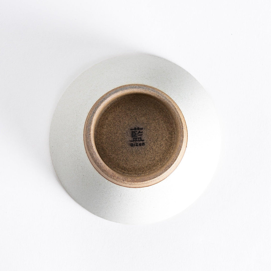 Bottom view of the white ceramic rice bowl, highlighting its sturdy, neutral-toned base.