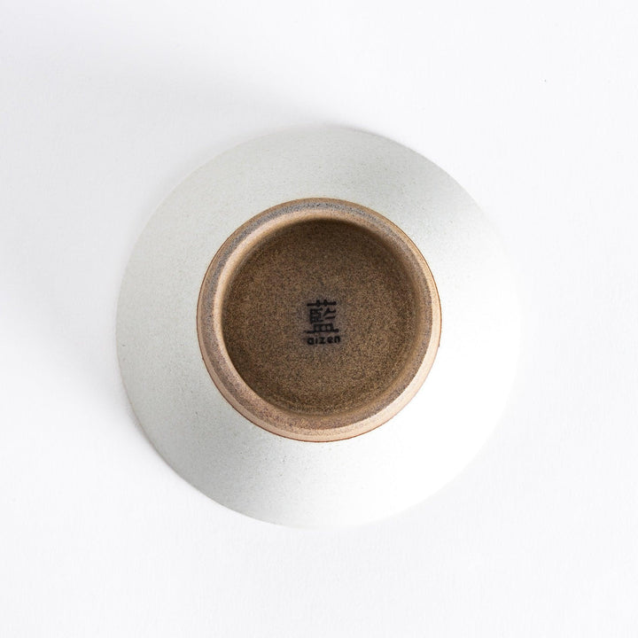 Bottom view of the white ceramic rice bowl, highlighting its sturdy, neutral-toned base.