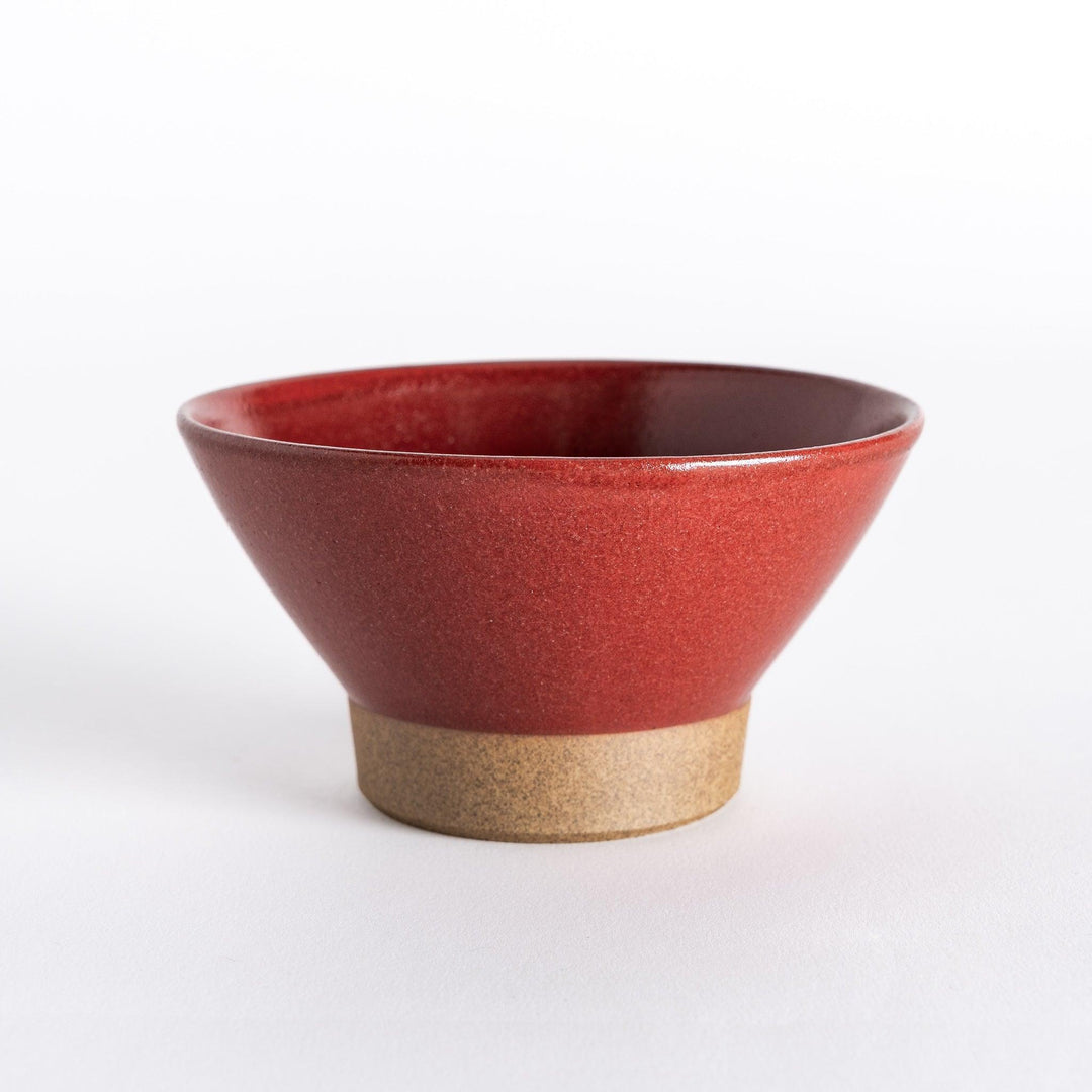Red ceramic rice bowl with a glossy finish and neutral base, shown directly from the front.
