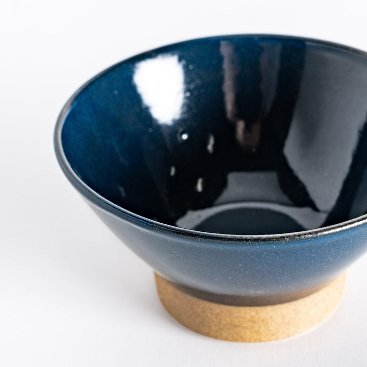 Close-up of the blue ceramic rice bowl, focusing on its deep blue hue, glossy finish, and neutral-toned base.