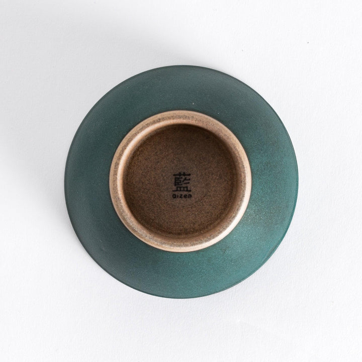Bottom view of the green ceramic rice bowl, featuring its neutral-toned base and smooth curves.