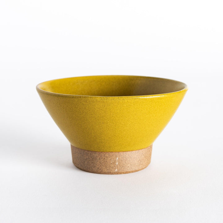 Yellow ceramic rice bowl with a glossy finish and neutral-toned base, displayed directly from the front.