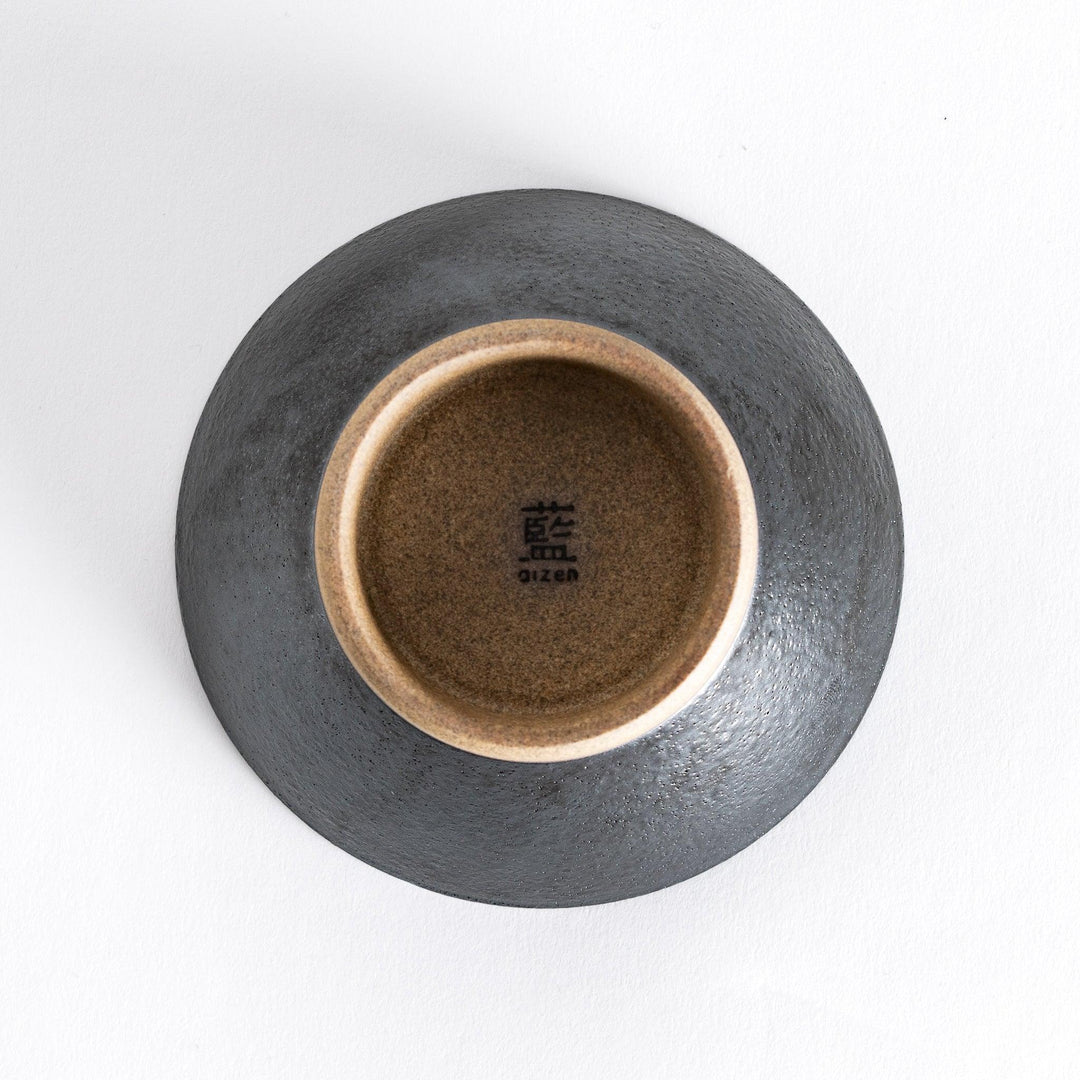Bottom view of the black ceramic rice bowl, showcasing its neutral-toned base and smooth finish.