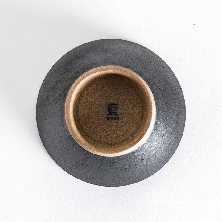 Bottom view of the black ceramic rice bowl, showcasing its neutral-toned base and smooth finish.