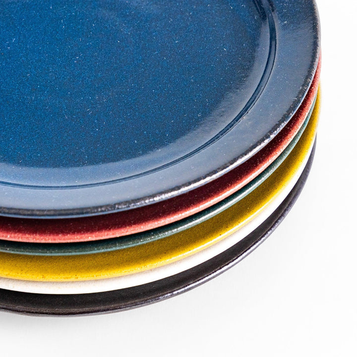 Colorful salad plate in blue red yellow white or black with smooth glossy finish adding vibrant touch to table.