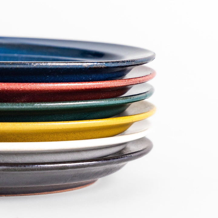 Colorful salad plate in blue red yellow white or black with smooth glossy finish adding vibrant touch to table.