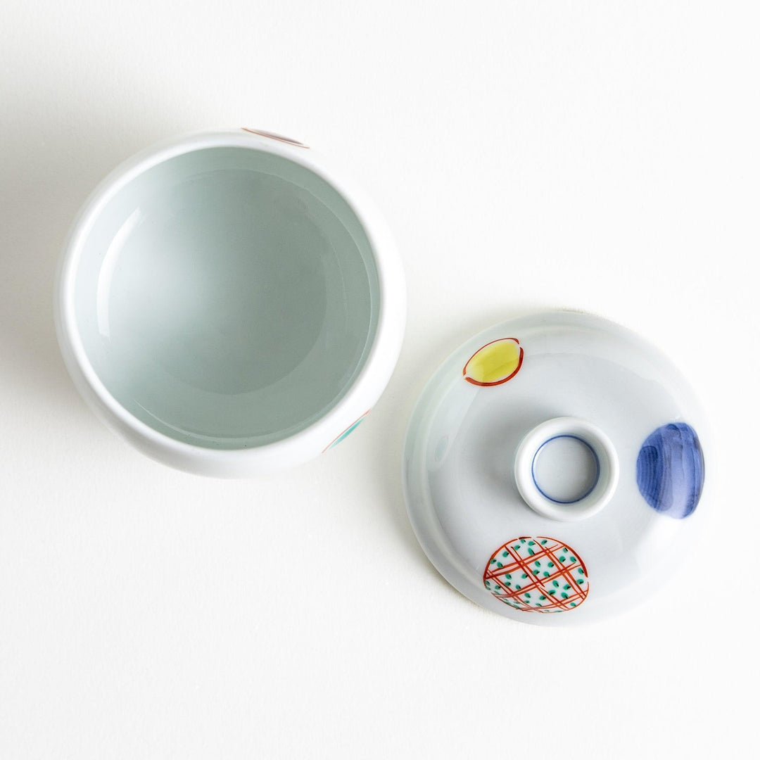 Japanese porcelain chawanmushi bowl with lid featuring colorful red blue and turquoise patterns on white background