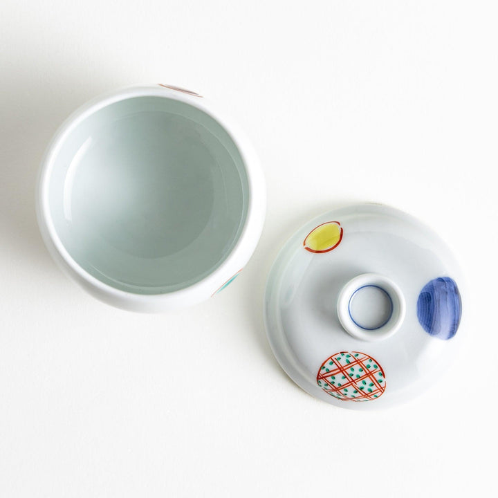 Japanese porcelain chawanmushi bowl with lid featuring colorful red blue and turquoise patterns on white background