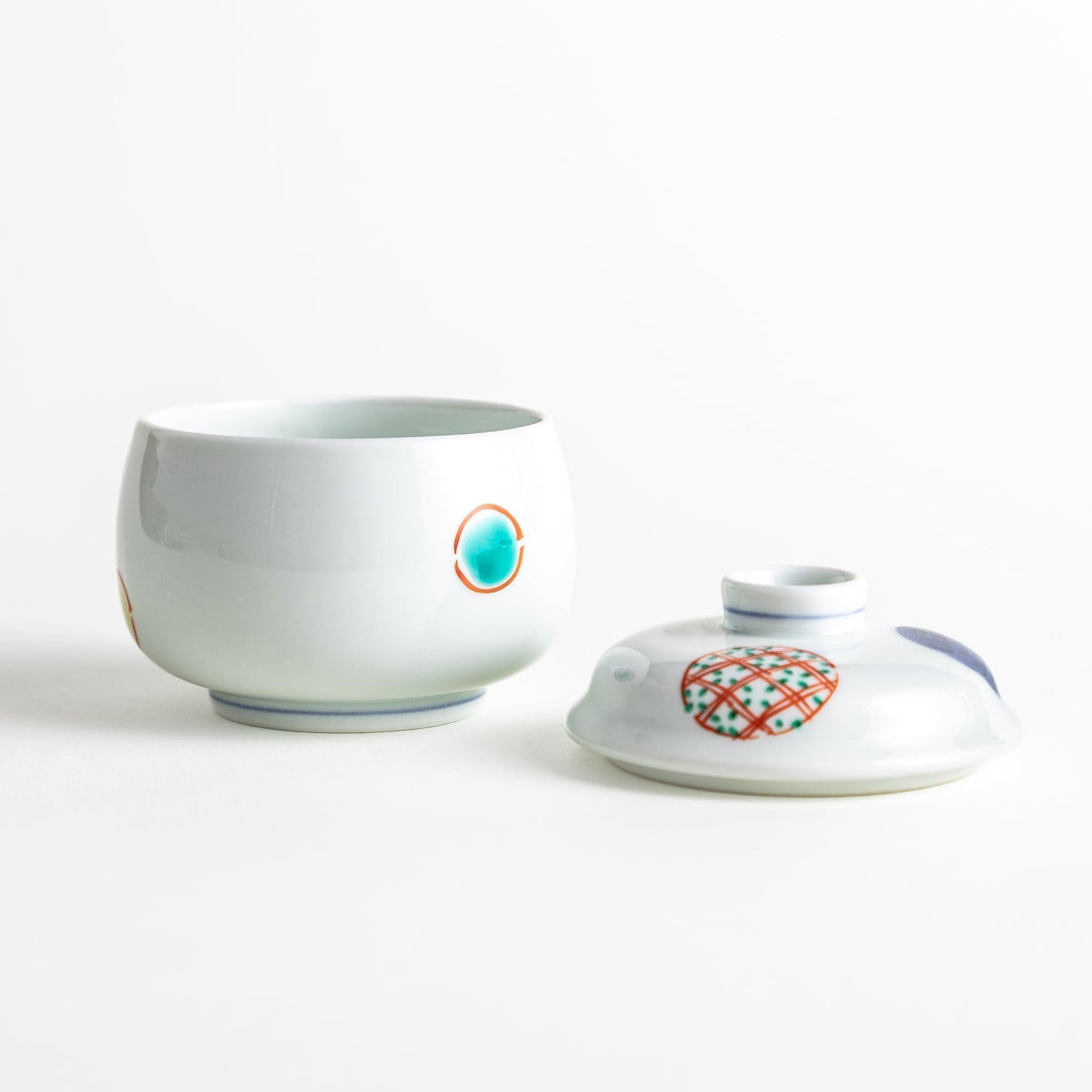 Japanese porcelain chawanmushi bowl with lid featuring colorful red blue and turquoise patterns on white background