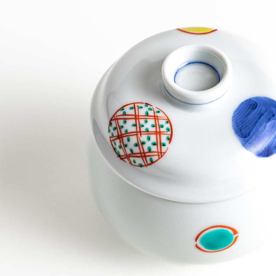 Japanese porcelain chawanmushi bowl with lid featuring colorful red blue and turquoise patterns on white background