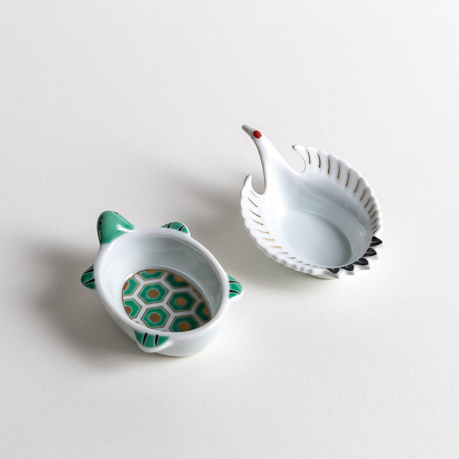 Turtle and crane shaped ceramic dishes with hexagon and wing patterns symbolizing longevity and harmony.