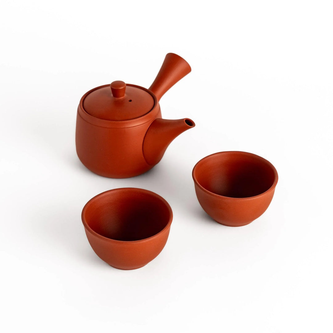 Crimson tea set with round teapot and matching bowls perfect for enjoying tea with elegant style.