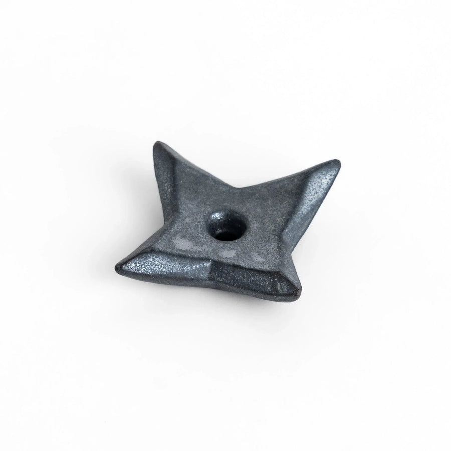 Ninja star shaped chopstick rest with metallic finish adding playful and stylish accent to Japanese dining.