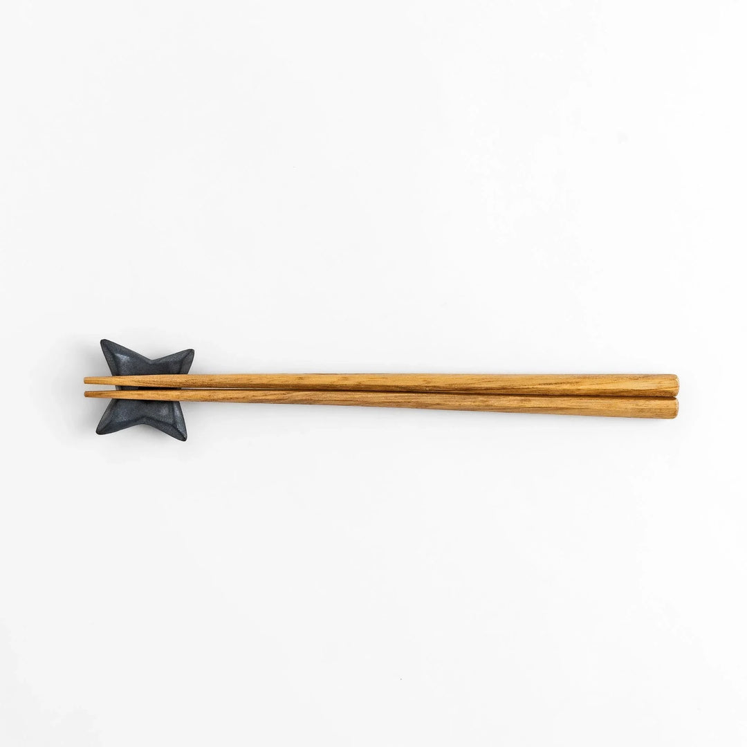 Ninja star shaped chopstick rest with metallic finish adding playful and stylish accent to Japanese dining.