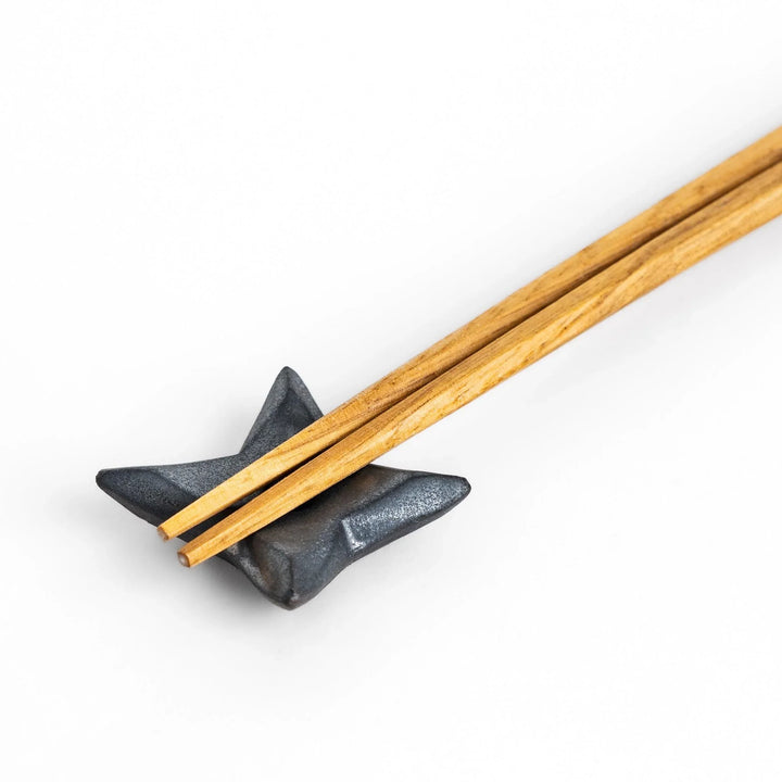 Ninja star shaped chopstick rest with metallic finish adding playful and stylish accent to Japanese dining.