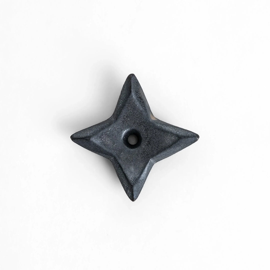 Ninja star shaped chopstick rest with metallic finish adding playful and stylish accent to Japanese dining.