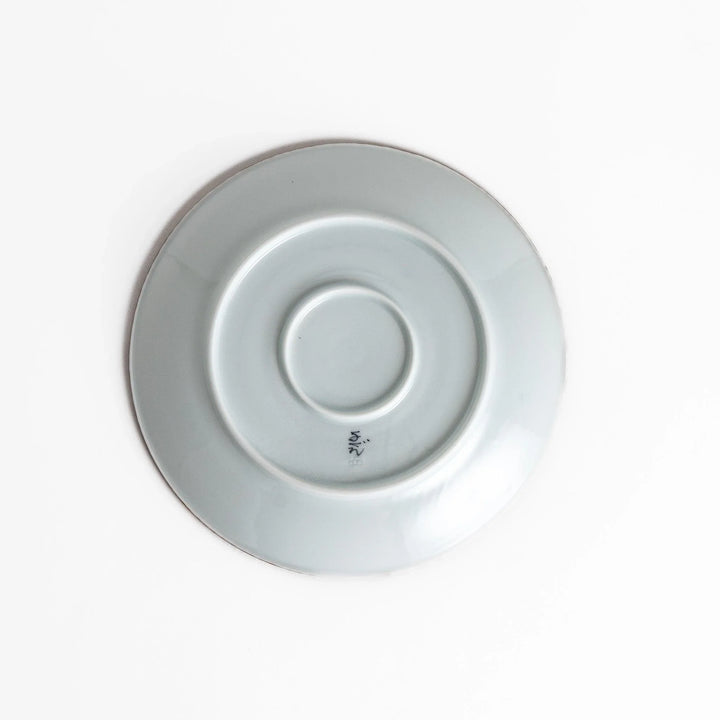 Ceramic plate with intricate blue floral design and bold circular motif framed by copper textured rim.