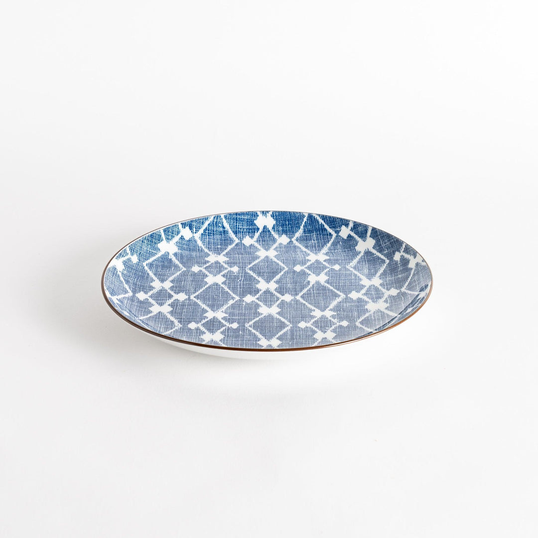 A round dinner plate displaying a blue and white lattice design, similar to traditional Japanese patterns.