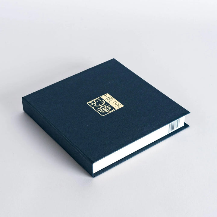 Set of four Japanese porcelain plates in gift box each with blue and red dinosaur design decoration.