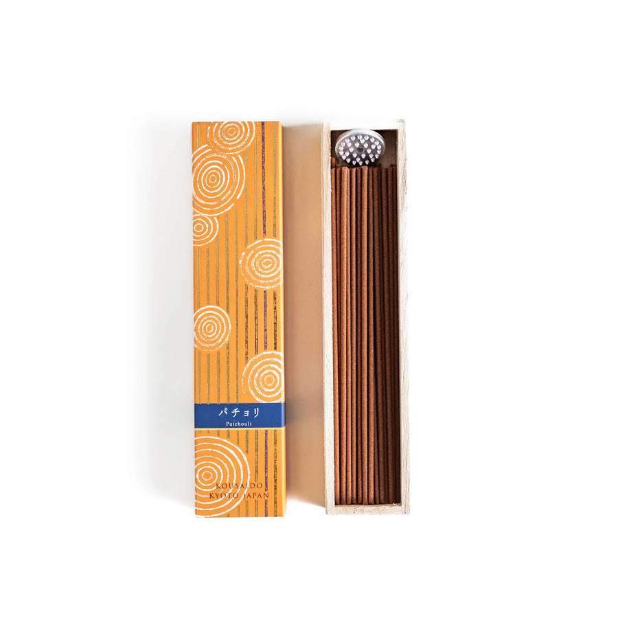 Japanese patchouli incense sticks in a wooden box with orange patterned sleeve from Kousaido Kyoto Japan.