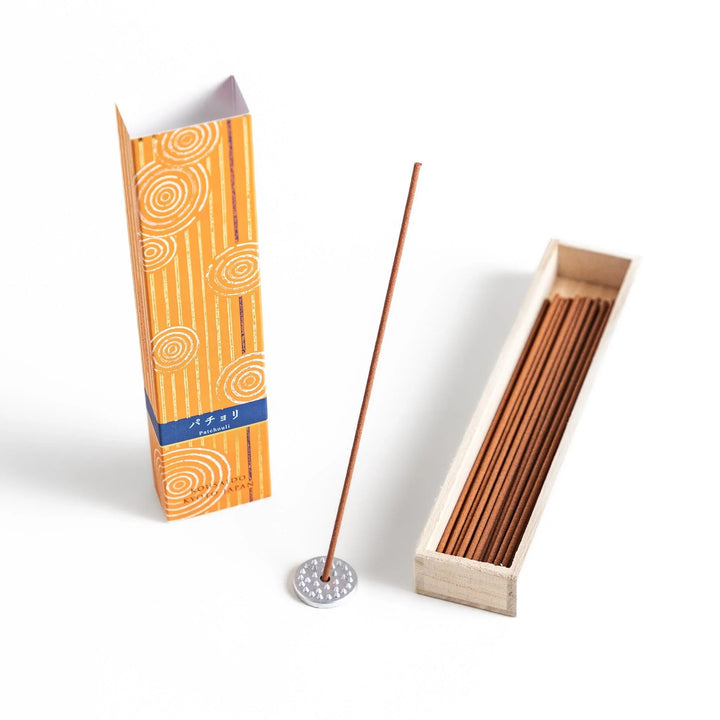 Japanese patchouli incense sticks in a wooden box with orange patterned sleeve from Kousaido Kyoto Japan.