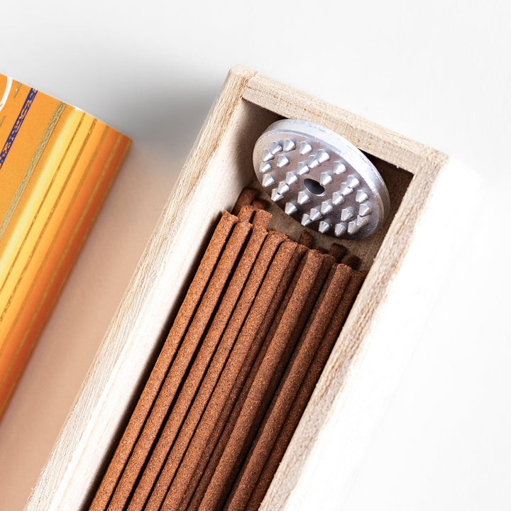 Japanese patchouli incense sticks in a wooden box with orange patterned sleeve from Kousaido Kyoto Japan.