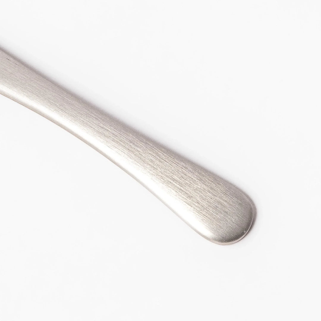Silver aluminum ice cream spoon with satin finish and flat edge for smoothly scooping hard frozen desserts.