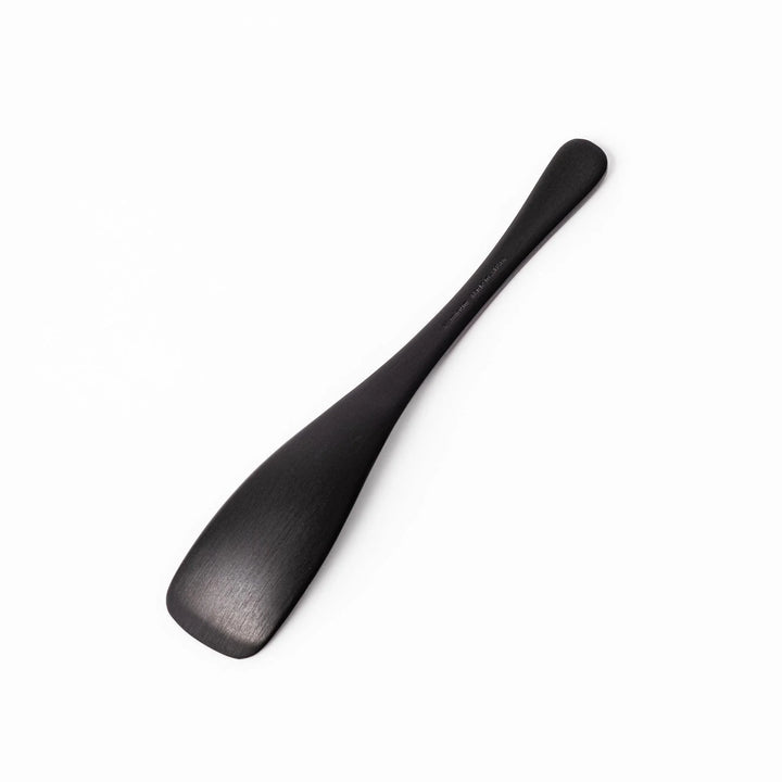 Matte black aluminum ice cream spoon with flat edge designed for easy scooping of firm frozen desserts.
