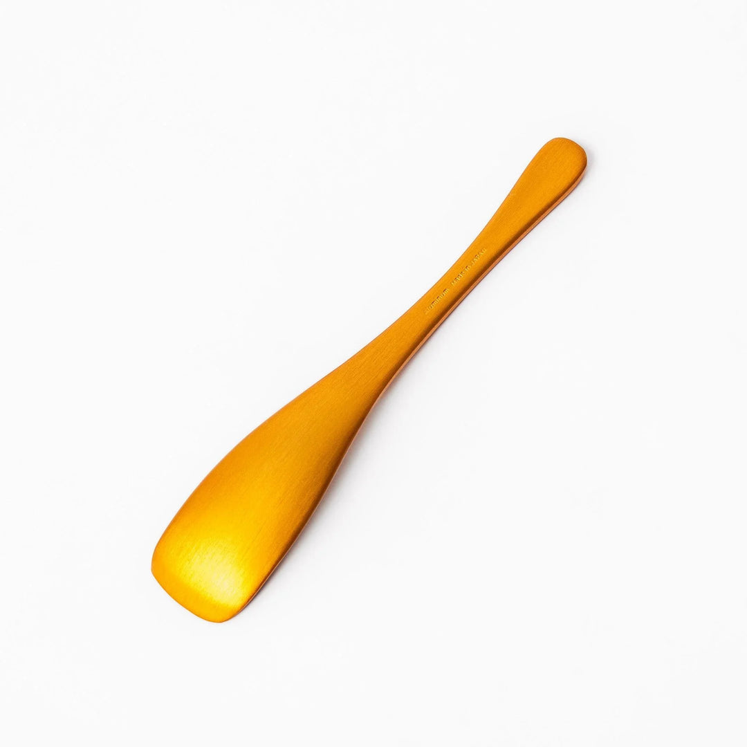 Gold aluminum ice cream spoon with matte finish and flat scoop edge designed to glide through hard ice cream.