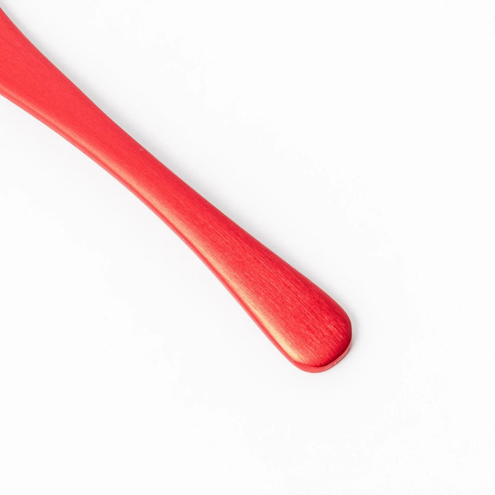 Red aluminum ice cream spoon with a flat edge and matte finish, designed to cut through hard ice cream with ease and comfort.