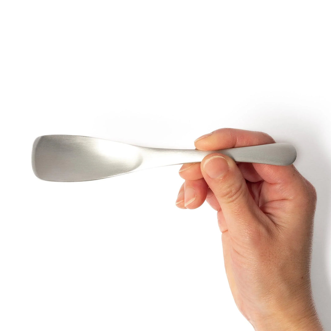 Silver aluminum ice cream spoon with satin finish and flat edge for smoothly scooping hard frozen desserts.
