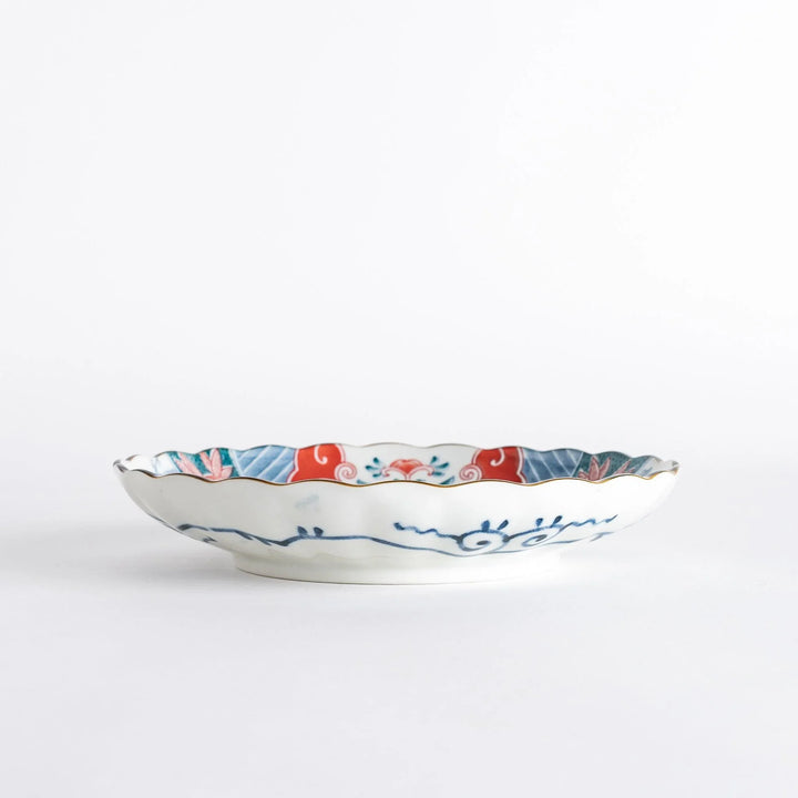 Profile view of the decorative plate, showing its depth and the vibrant colors of the design.