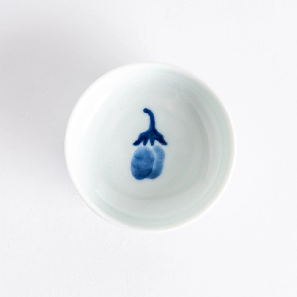 Small raised Japanese sauce dish with blue eggplant design inside and vertical blue lines along the edge.