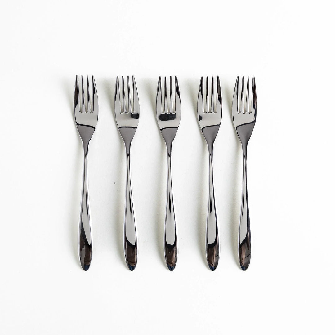Five elegant stainless steel forks arranged vertically on a white background.